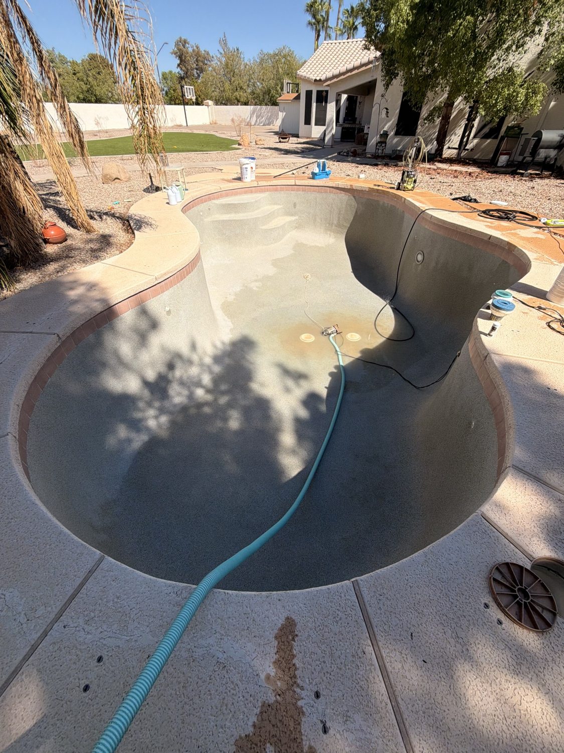 Same pool after removal of debris and algae, empty and awaiting refill